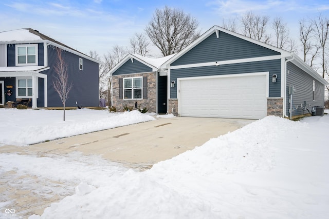 view of front of property with a garage and central AC unit