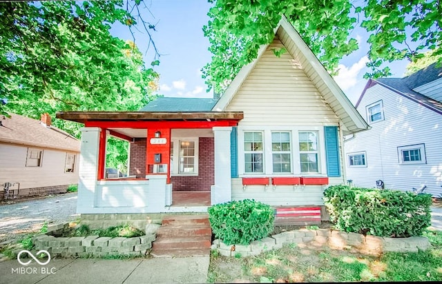 rear view of property with covered porch