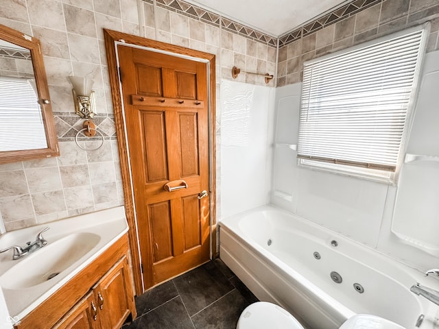 bathroom featuring tile walls, vanity, shower / bathing tub combination, and tile patterned floors