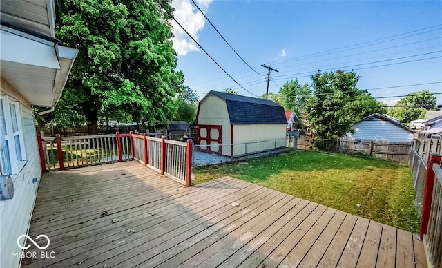 deck with a storage shed and a lawn