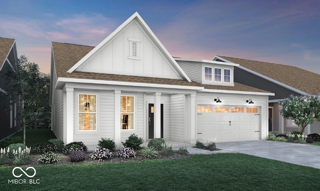 view of front of house featuring a yard and a garage