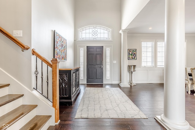 8526 Oakmont Ln, Indianapolis, IN 46260 - foyer with ornamental molding, dark hardwood / wood-style floors, a high ceiling, and ornate columns
