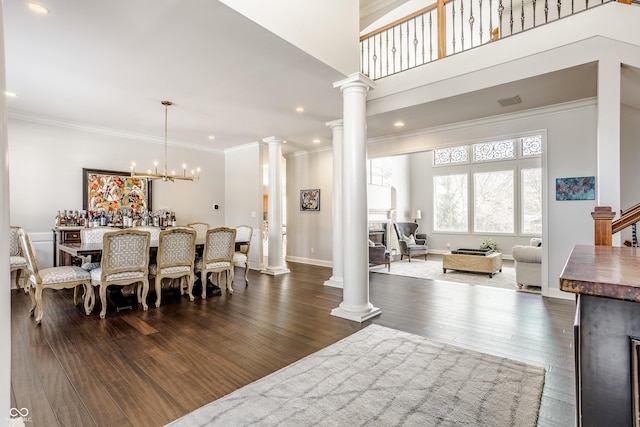 8526 Oakmont Ln, Indianapolis, IN 46260 - dining area featuring crown molding, dark hardwood / wood-style floors, an inviting chandelier, and ornate columns