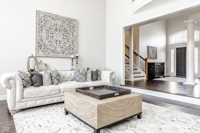 8526 Oakmont Ln, Indianapolis, IN 46260 - living room featuring ornate columns, a high ceiling, and hardwood / wood-style floors