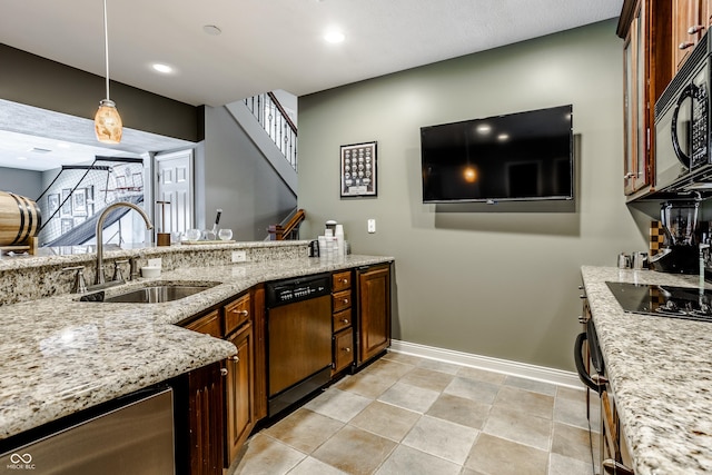 8526 Oakmont Ln, Indianapolis, IN 46260 - kitchen featuring light stone counters, sink, hanging light fixtures, and black appliances