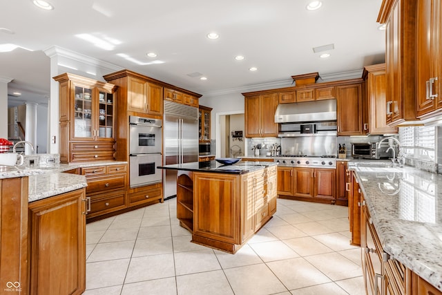 8526 Oakmont Ln, Indianapolis, IN 46260 - kitchen with light stone counters, appliances with stainless steel finishes, and a kitchen island