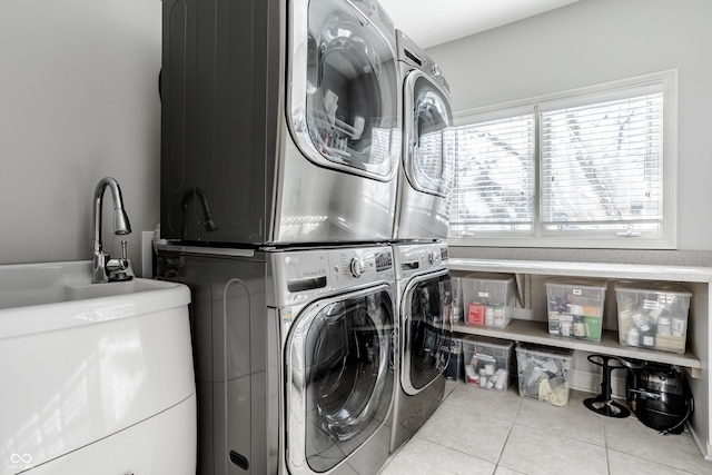 8526 Oakmont Ln, Indianapolis, IN 46260 - laundry room featuring light tile patterned flooring, stacked washer and clothes dryer, and sink