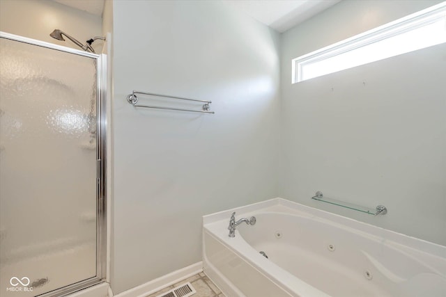 bathroom featuring independent shower and bath