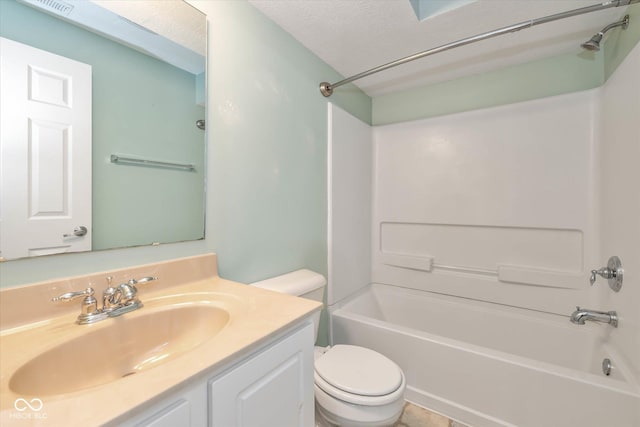 full bathroom with vanity, washtub / shower combination, a textured ceiling, and toilet