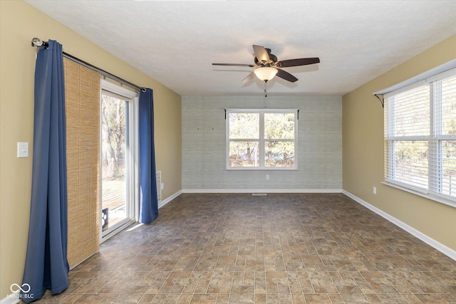 spare room with ceiling fan and a textured ceiling