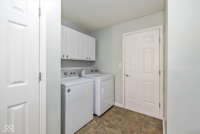 washroom featuring cabinets and separate washer and dryer