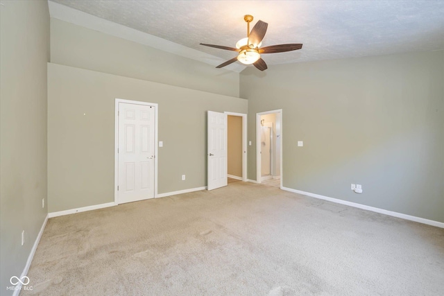 unfurnished bedroom with ceiling fan, high vaulted ceiling, light colored carpet, and a textured ceiling