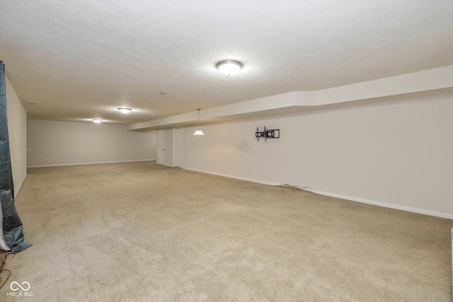 basement with a textured ceiling and carpet