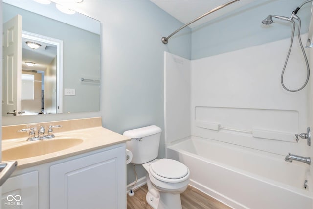 full bathroom with vanity, toilet, tub / shower combination, and hardwood / wood-style floors