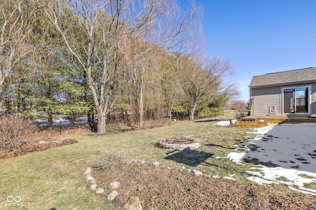 view of yard with a fire pit