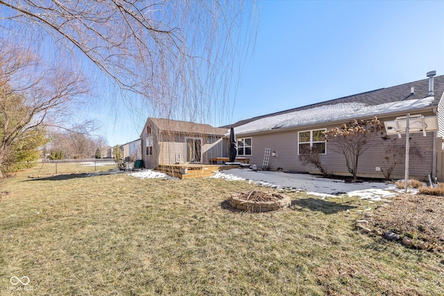 back of house with a patio, a lawn, and an outdoor fire pit