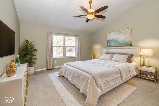 carpeted bedroom with vaulted ceiling and ceiling fan