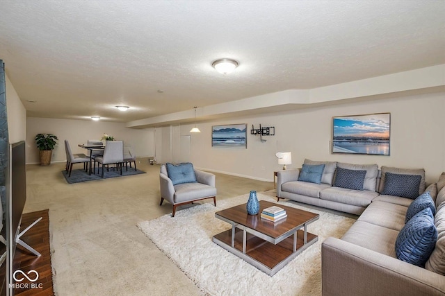 carpeted living room with a textured ceiling