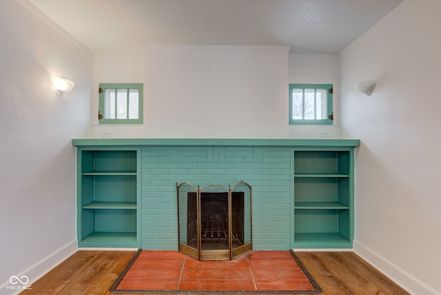 unfurnished living room featuring hardwood / wood-style flooring and a fireplace