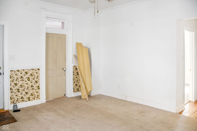 carpeted spare room with crown molding