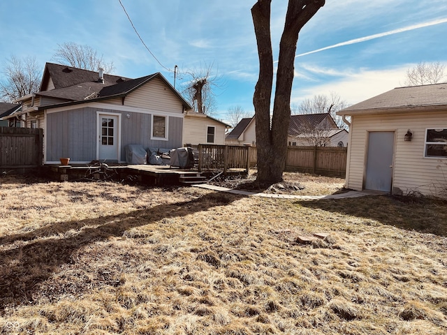 back of house with a yard and a deck