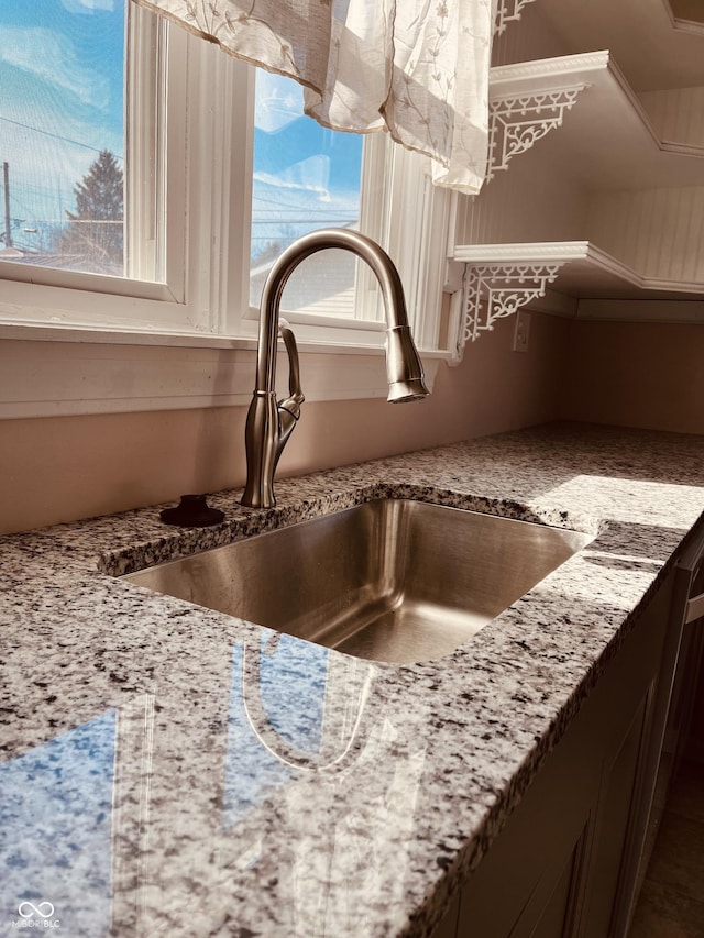 room details with light stone countertops and sink