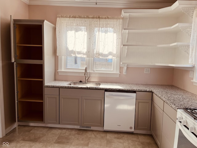 kitchen featuring sink, light stone counters, and white appliances