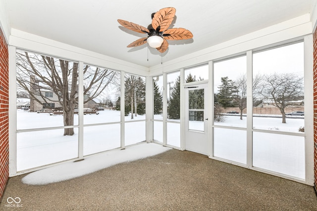 unfurnished sunroom with ceiling fan