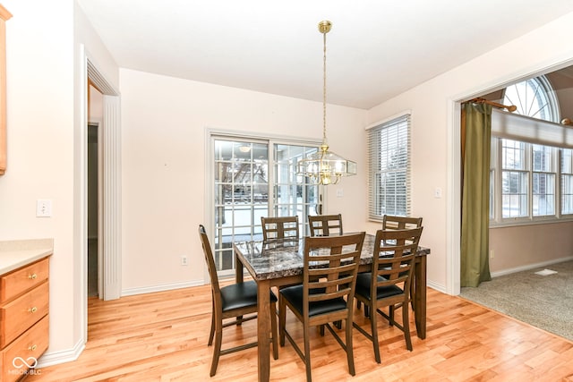 dining room featuring a chandelier and light wood-type flooring