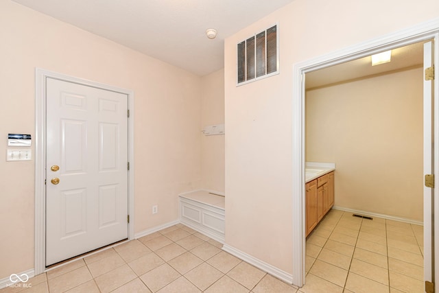 foyer featuring light tile patterned floors