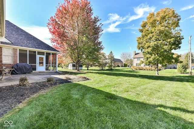 view of yard featuring a sunroom and a patio