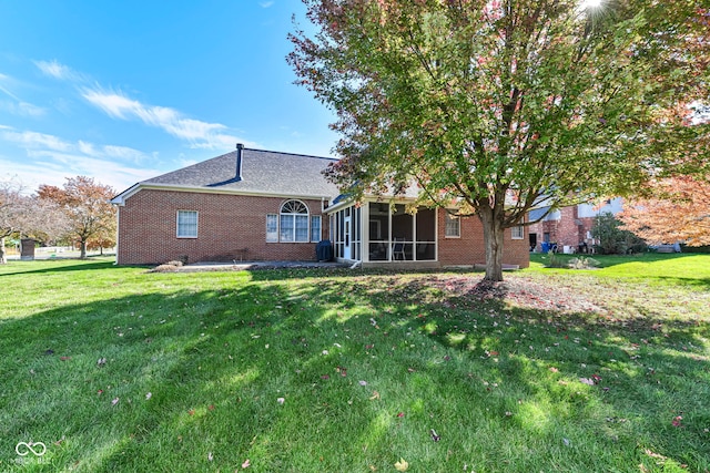 back of house with a sunroom and a yard