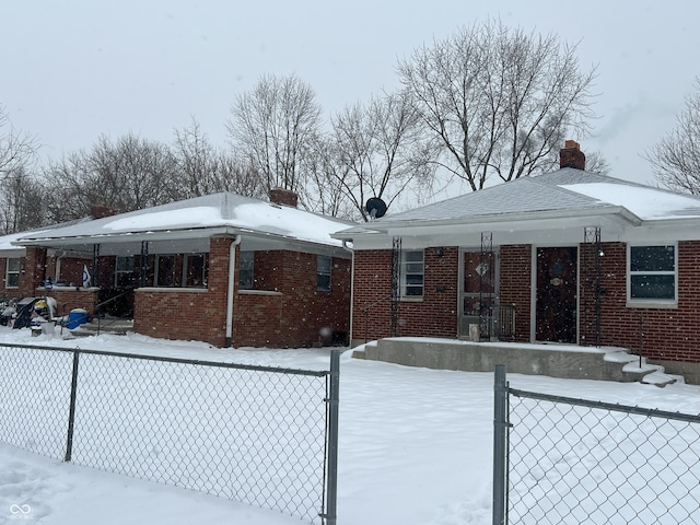 snow covered rear of property featuring a porch