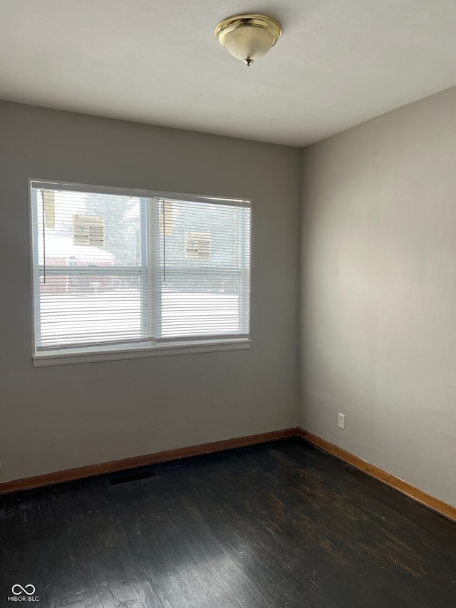 spare room featuring dark hardwood / wood-style floors