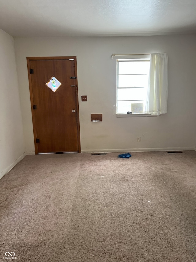 view of carpeted foyer