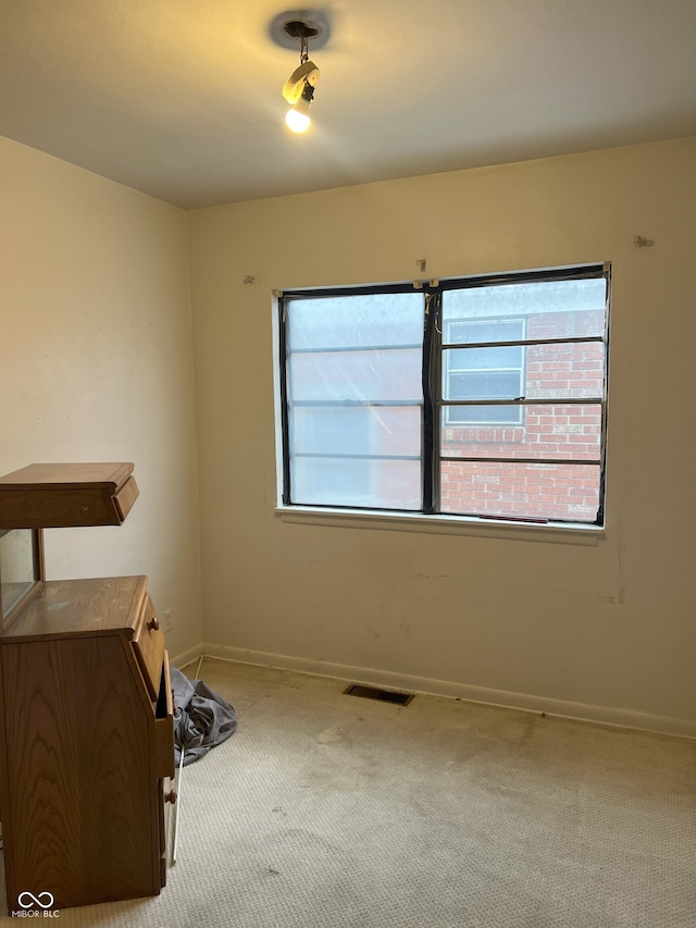 empty room featuring light carpet