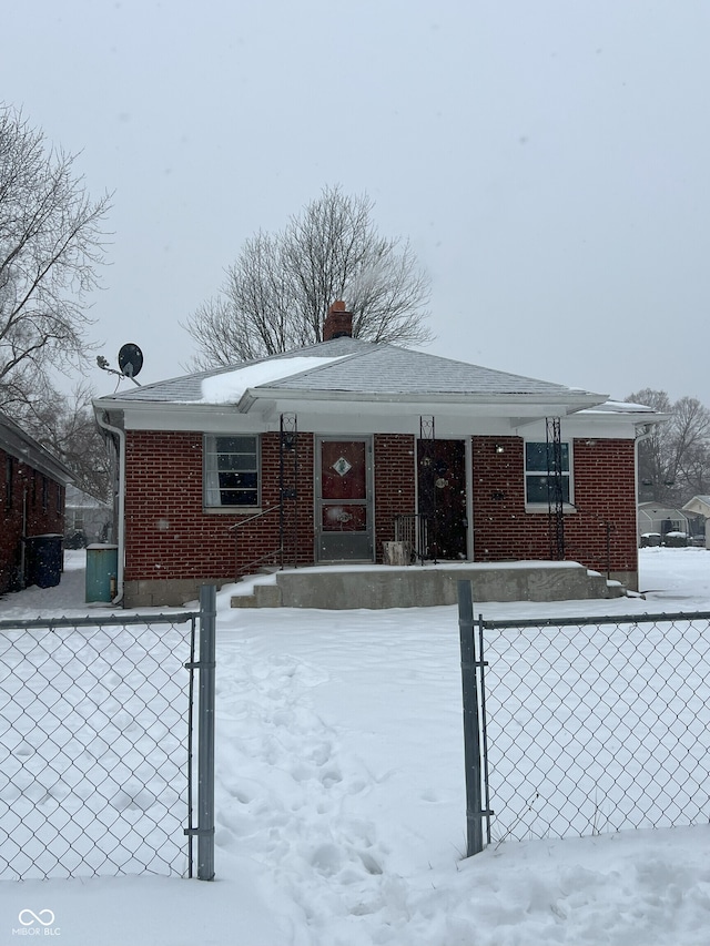 view of snow covered back of property