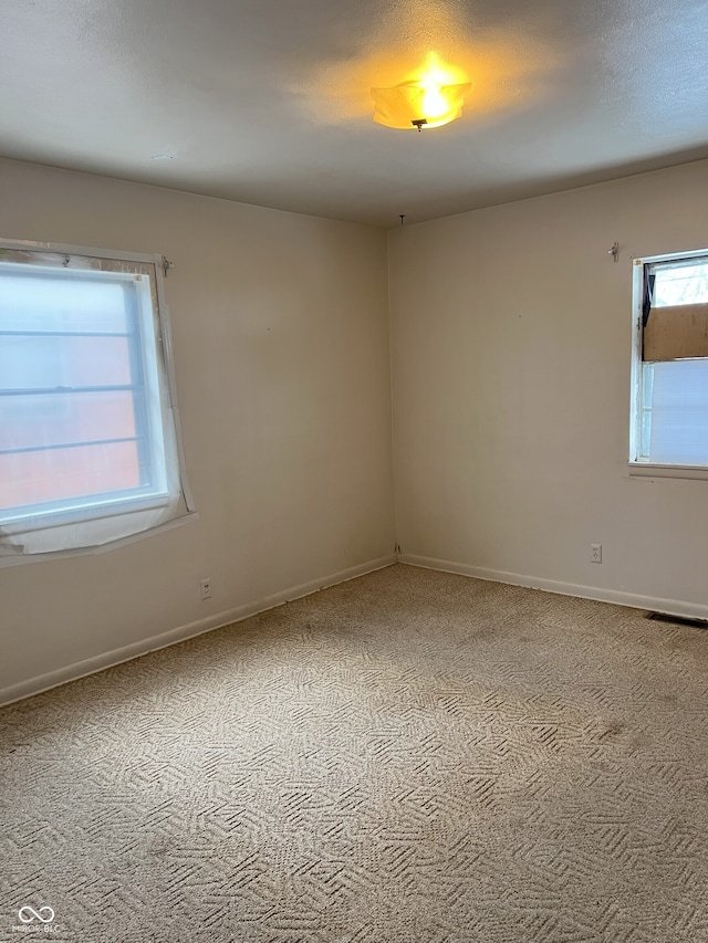 empty room featuring light colored carpet