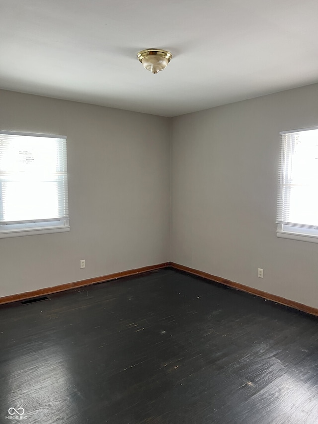 empty room featuring dark wood-type flooring