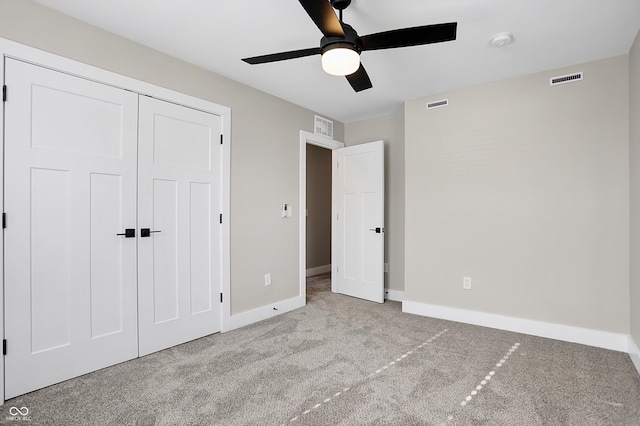 unfurnished bedroom featuring ceiling fan, a closet, and light carpet