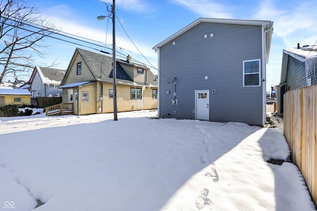 view of snow covered back of property