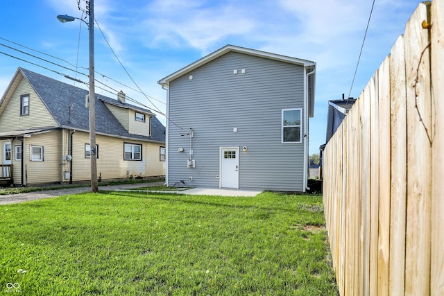 1446 E Naomi St, Indianapolis, IN 46203 - back of property with a lawn, fence, and a patio