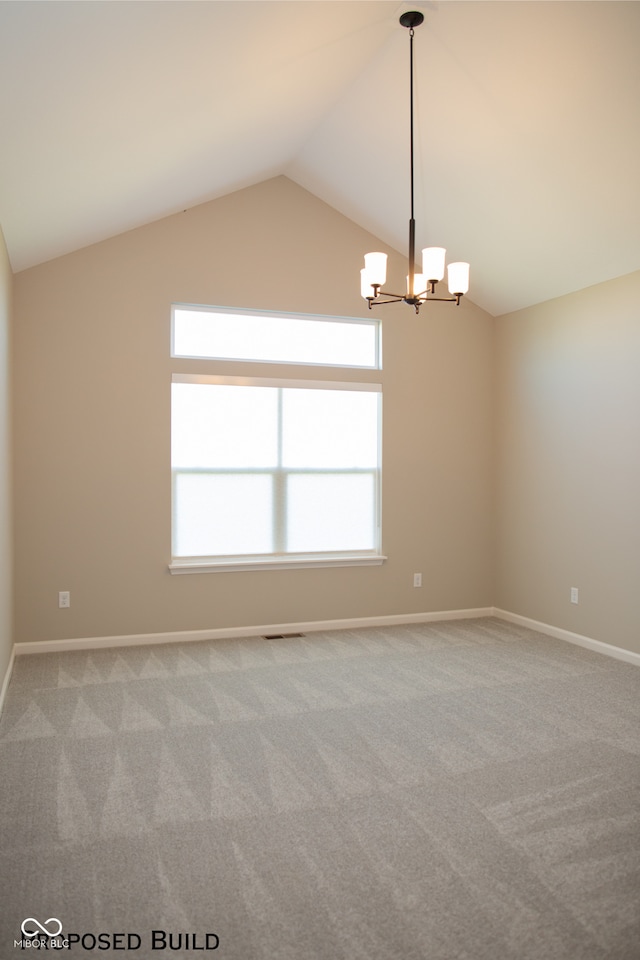 unfurnished room with vaulted ceiling, a notable chandelier, and carpet flooring