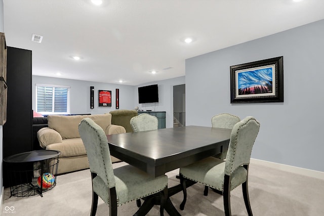 dining room featuring light carpet