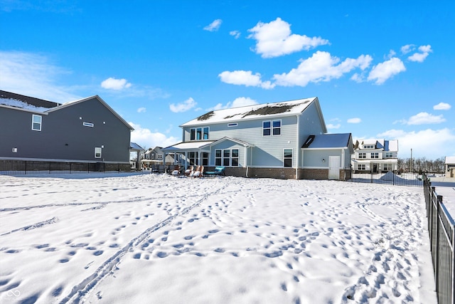 view of snow covered back of property