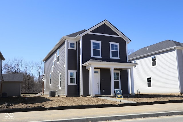 view of front of property featuring cooling unit, covered porch, and board and batten siding