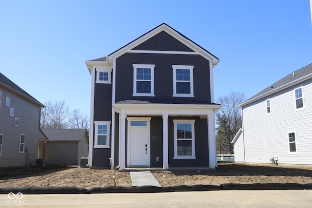 view of front of house featuring cooling unit, board and batten siding, and a porch