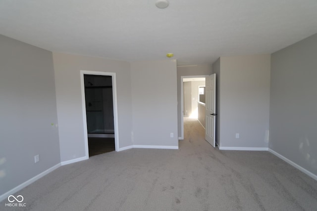 unfurnished bedroom with baseboards and carpet flooring