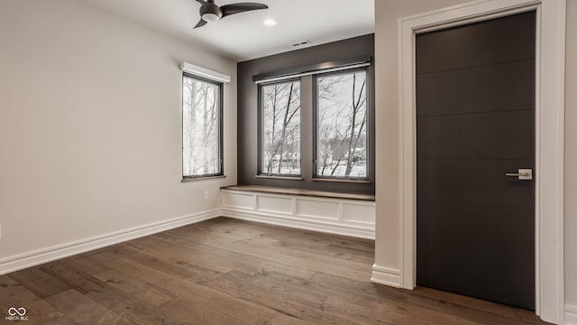 unfurnished room with ceiling fan and wood-type flooring