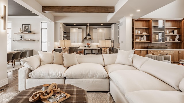 living room with beam ceiling and light hardwood / wood-style flooring